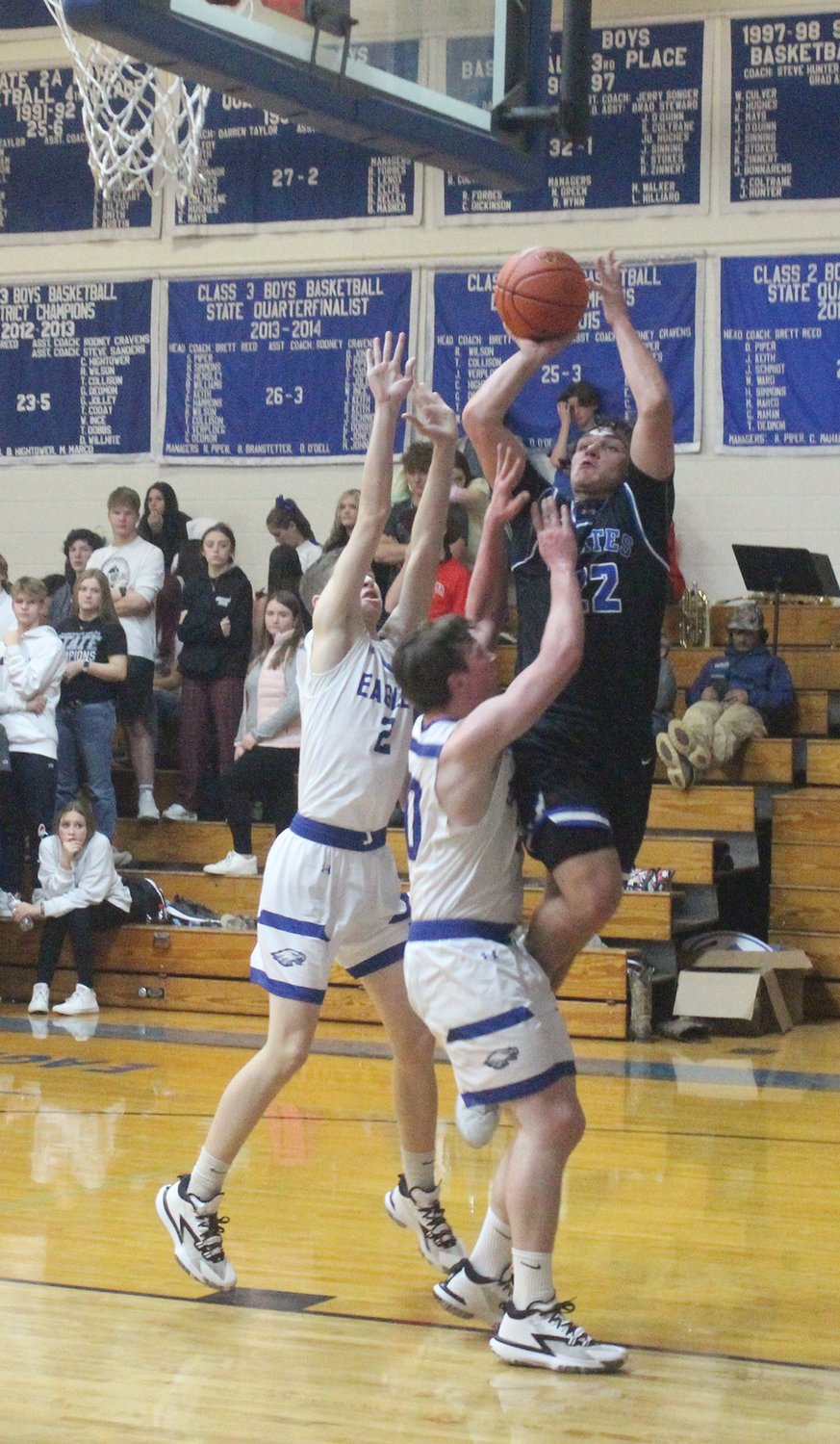 Norwood’s Gavin McGraw takes a shot while being defended by Hartville’s Jalon Cryer and Jackson Ward.